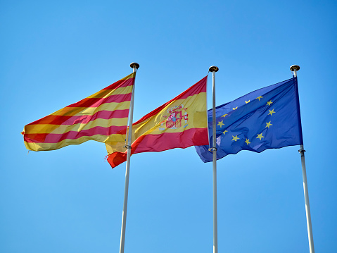 Banderas de Cataluña, España y Europa Unión agitando. photo