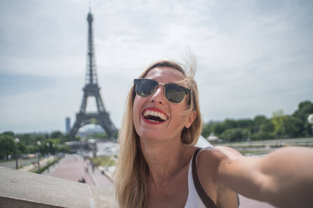 istock Young woman taking selfie in Paris city using mobile phone 1006550680
