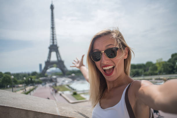 istock Blond hair female enjoying vacations in Paris, selfie at Eiffel Tower 1006550778