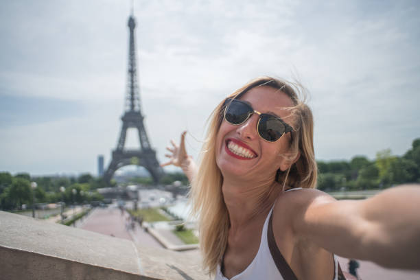istock Young woman taking selfie in Paris city using mobile phone 1006552966