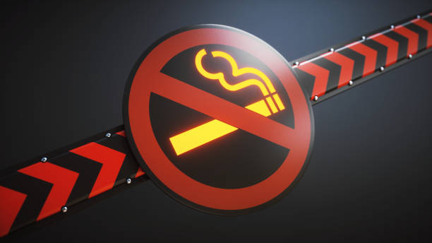 istock Glowing no smoking sign & striped security barrier close up 1006556018