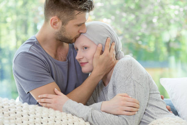 istock Man kissing his sick girlfriend on the forehead 1006556050