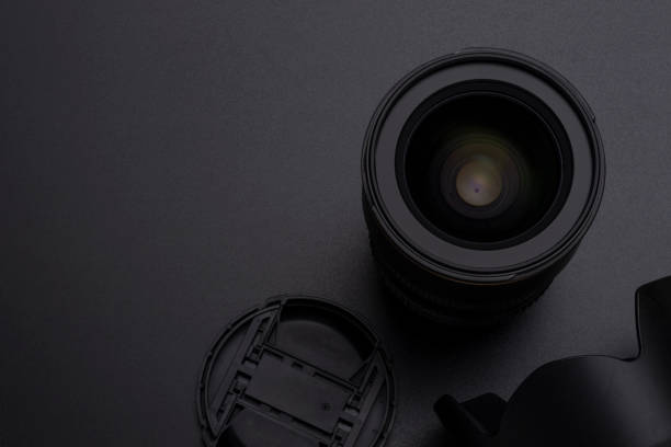 istock Photo DSLR camera or video lens, hood and front cap close-up image 1006556314