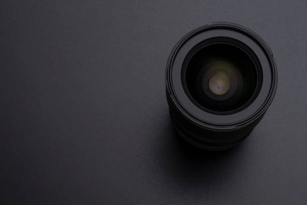 istock Camera or video lens close-up image on black background 1006556336