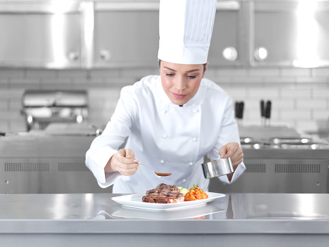 Chef preparing steak plate