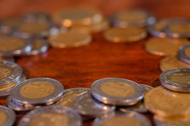 Mexican Coins in a round on a table of wood stock photo