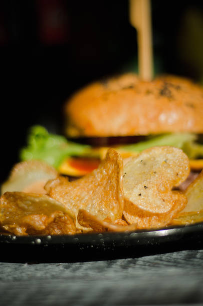 Fries on a plate with a rustic hamburger stock photo