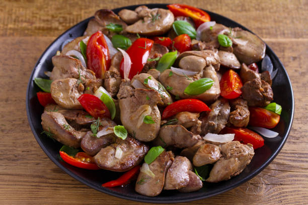 istock Chicken liver with plum cherry tomatoes, onion and basil 1006560488