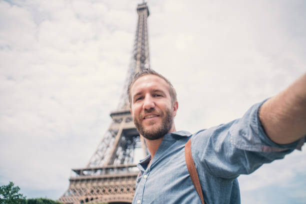istock Young man taking selfie in Paris city using mobile phone 1006562684