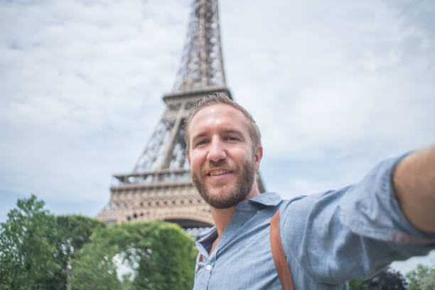 istock Young man taking selfie in Paris city using mobile phone 1006562686