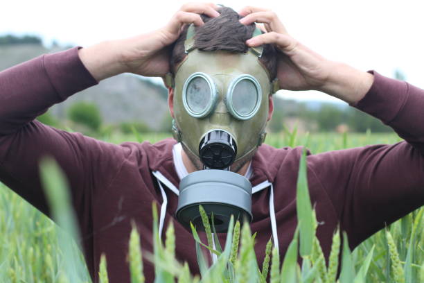 istock Man wearing breathing mask in wheat field 1006562728