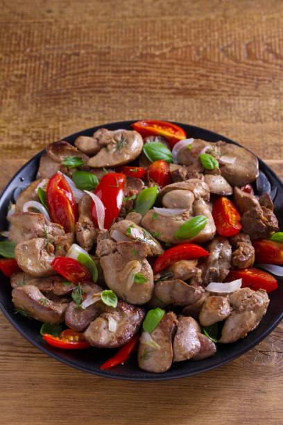 istock Chicken liver with plum cherry tomatoes, onion and basil 1006562824