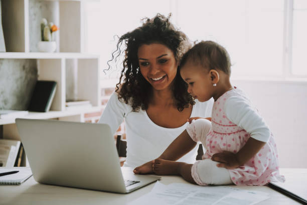 istock Young Smiling Freelancer with Daughter at Home. 1006566820