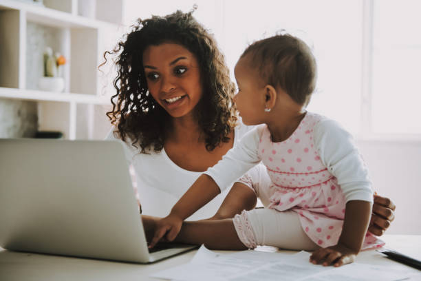 istock Young Smiling Freelancer with Daughter at Home. 1006566826
