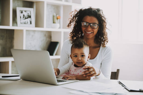 istock Young Smiling Freelancer with Daughter at Home. 1006566838