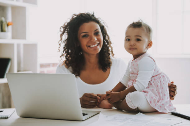 istock Young Smiling Freelancer with Daughter at Home. 1006566842