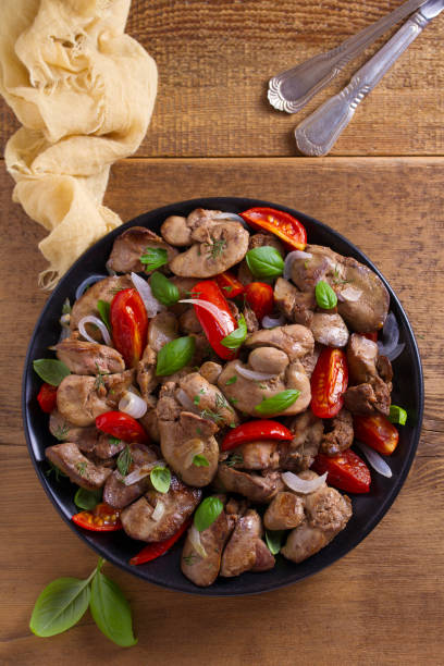 istock Chicken liver with plum cherry tomatoes, onion and basil 1006567800