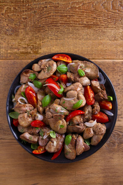 istock Chicken liver with plum cherry tomatoes, onion and basil 1006570024