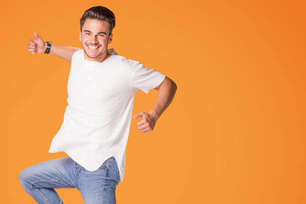 istock Happy handsome man jumping with big smile. 1006573890