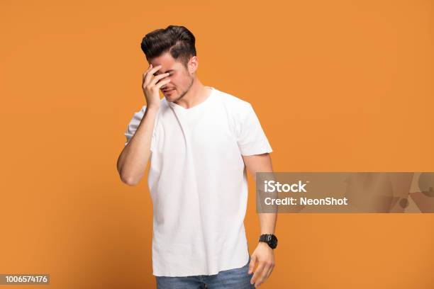 Disappointed Young Man On Yellow Background Stock Photo - Download Image Now - Disappointment, Men, One Person