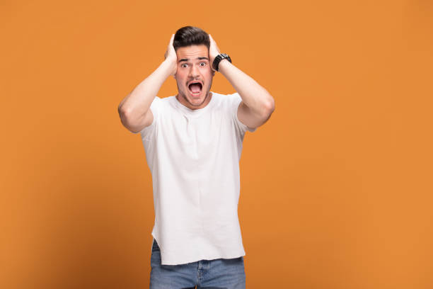 istock Happy handsome man on yellow background. 1006574244