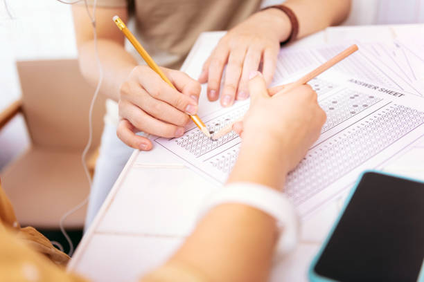 istock Student wearing black bracelet helping his group mate 1006574426