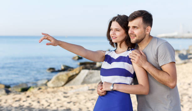 istock Young couple pointing to something interesting 1006575066