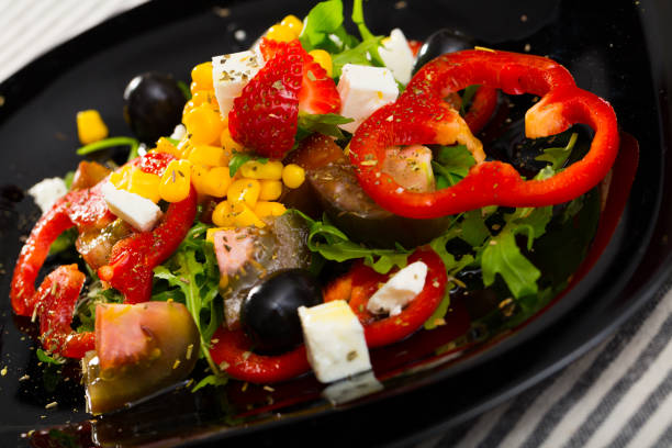 istock Salad with arugula, vegetables, strawberries and feta cheese 1006575392