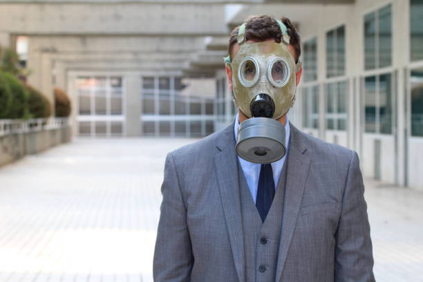 Businessman wearing gas mask in office space