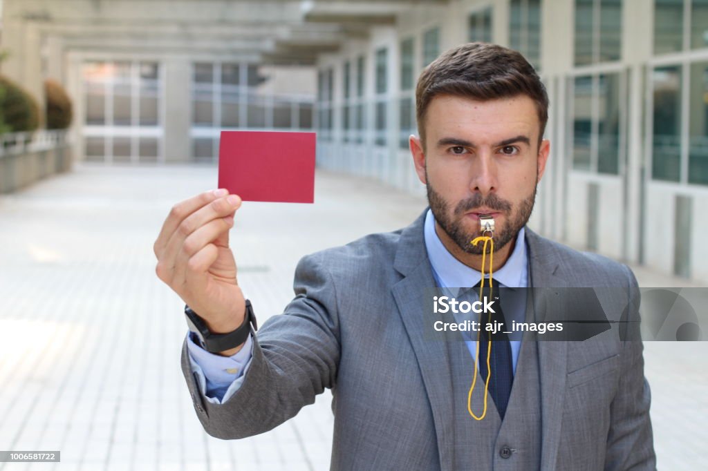 Businessman with whistle and red card Businessman with whistle and red card. Whistle Stock Photo