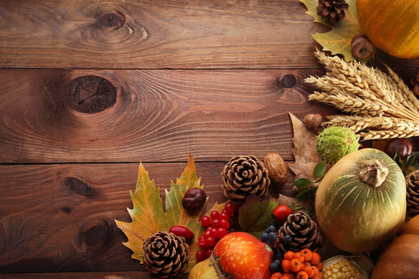 istock Autumn leafs with berries and vegetables on grey wooden table 1006582316