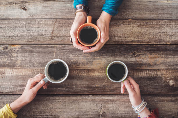 istock People hands holding a cup of coffee 1006582566