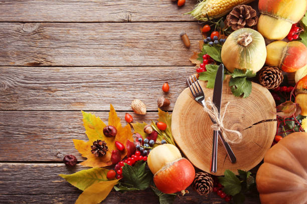 istock Autumn leafs with berries and vegetables on grey wooden table 1006582614