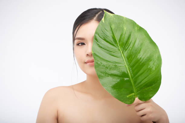 istock Beautiful woman closing face with leaf 1006582834