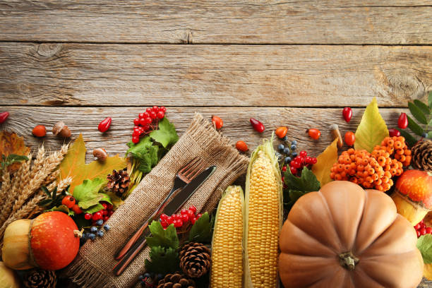 istock Autumn leafs with berries and vegetables on grey wooden table 1006587842