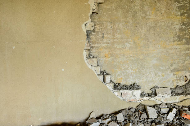 istock Partially destroyed wall inside an industrial building under demolition 1006587982