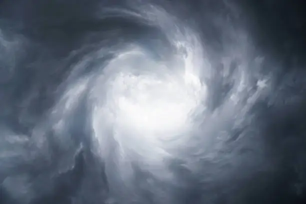 Dark, grim, stormy, rainy sky with rays of light. Scary hurricane clouds. Natural element. Stock Photo for your design