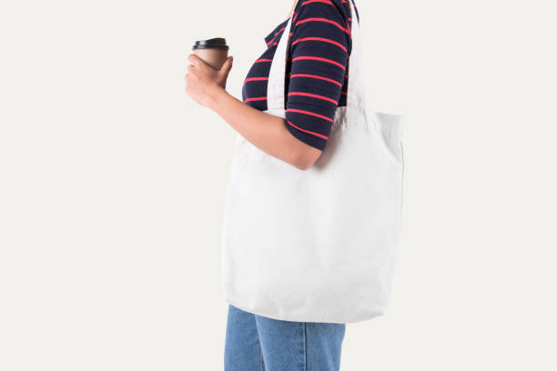 istock Girl is holding bag canvas fabric for mockup blank template isolated on white background. 1006592918