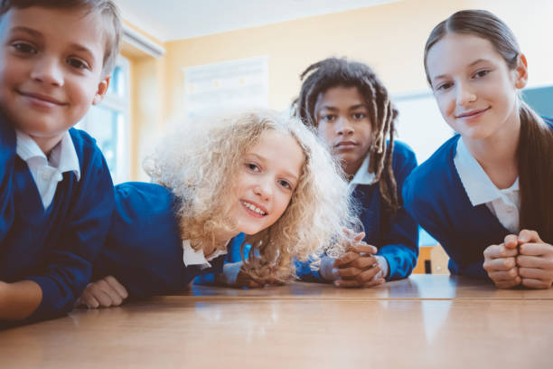 istock Smiling teenage students in classroom 1006594026
