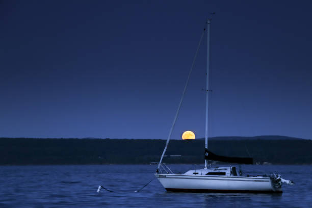 Full moons photographed in nautical, rural landscape, farm, and mountain settings in New England USA