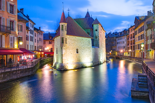 The Palais de l'Isle and Thiou river during morning blue hour in old city of Annecy, Venice of the Alps, France