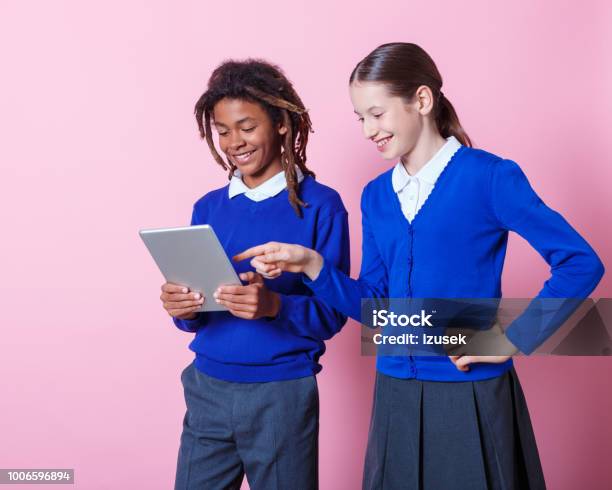 Two Students Using Digital Tablet Stock Photo - Download Image Now - Teenager, 12-13 Years, School Uniform