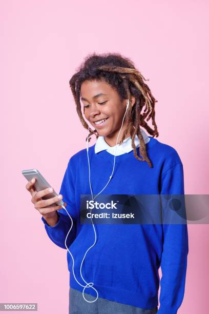 Teen Student Listening Music With Phone Stock Photo - Download Image Now - Colored Background, Telephone, Boys