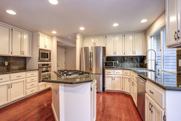 istock White kitchen room with stainless steel appliances. 1006597858