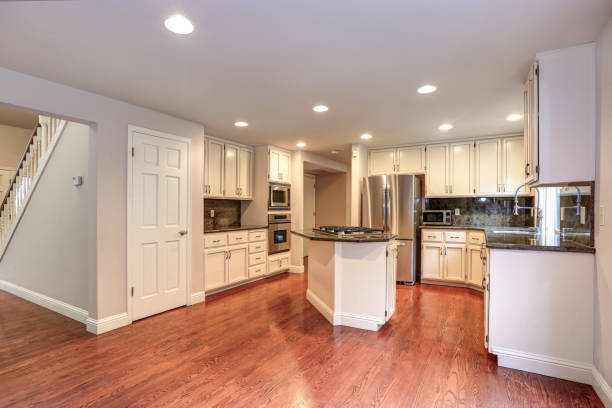 istock White kitchen room with stainless steel appliances. 1006597920