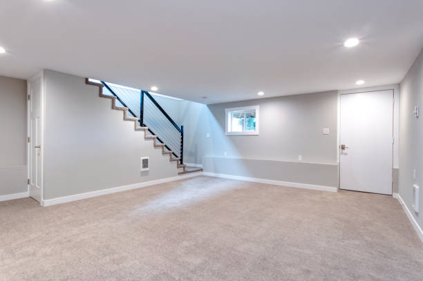 Light spacious basement area with staircase. stock photo