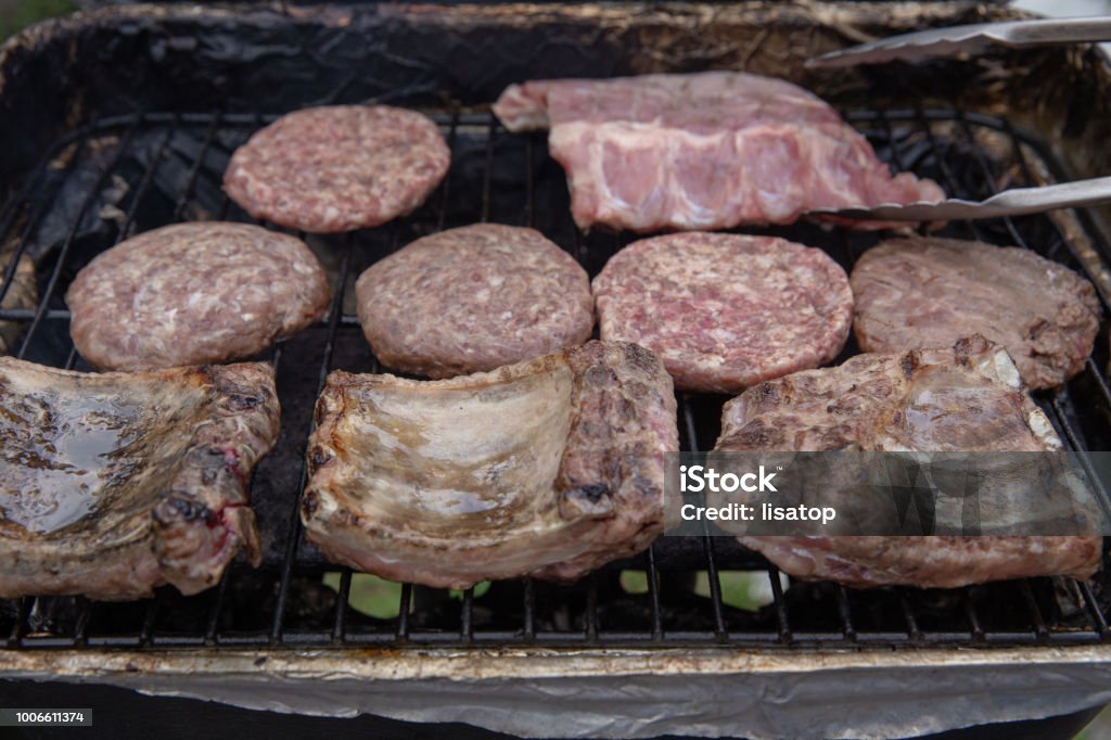meat being cooked on the grill Different types of meat being cooked on the grill Barbecue - Meal Stock Photo