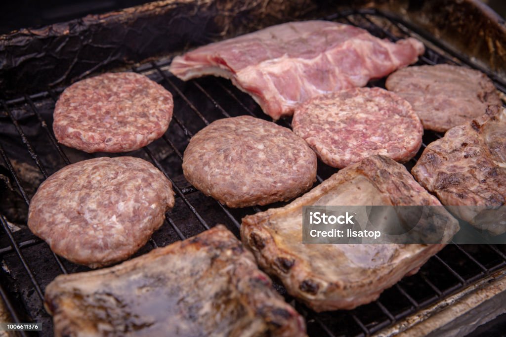 Barbecuing meats on the grill Barbecue - Meal Stock Photo