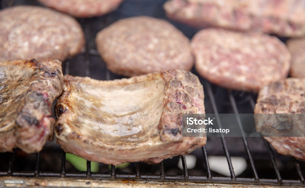 Cooking meat Cooking meat over a gas grill Barbecue - Meal Stock Photo