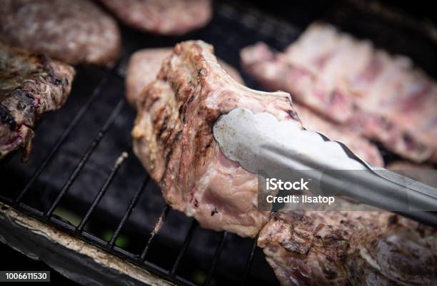 Turning Over Ribs Stock Photo - Download Image Now - Barbecue - Meal, Barbecue Grill, Beef